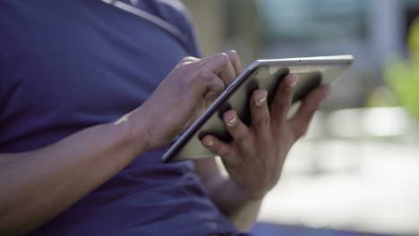 Closeup-of-Afro-American-male-hands-holding-tablet,-typing